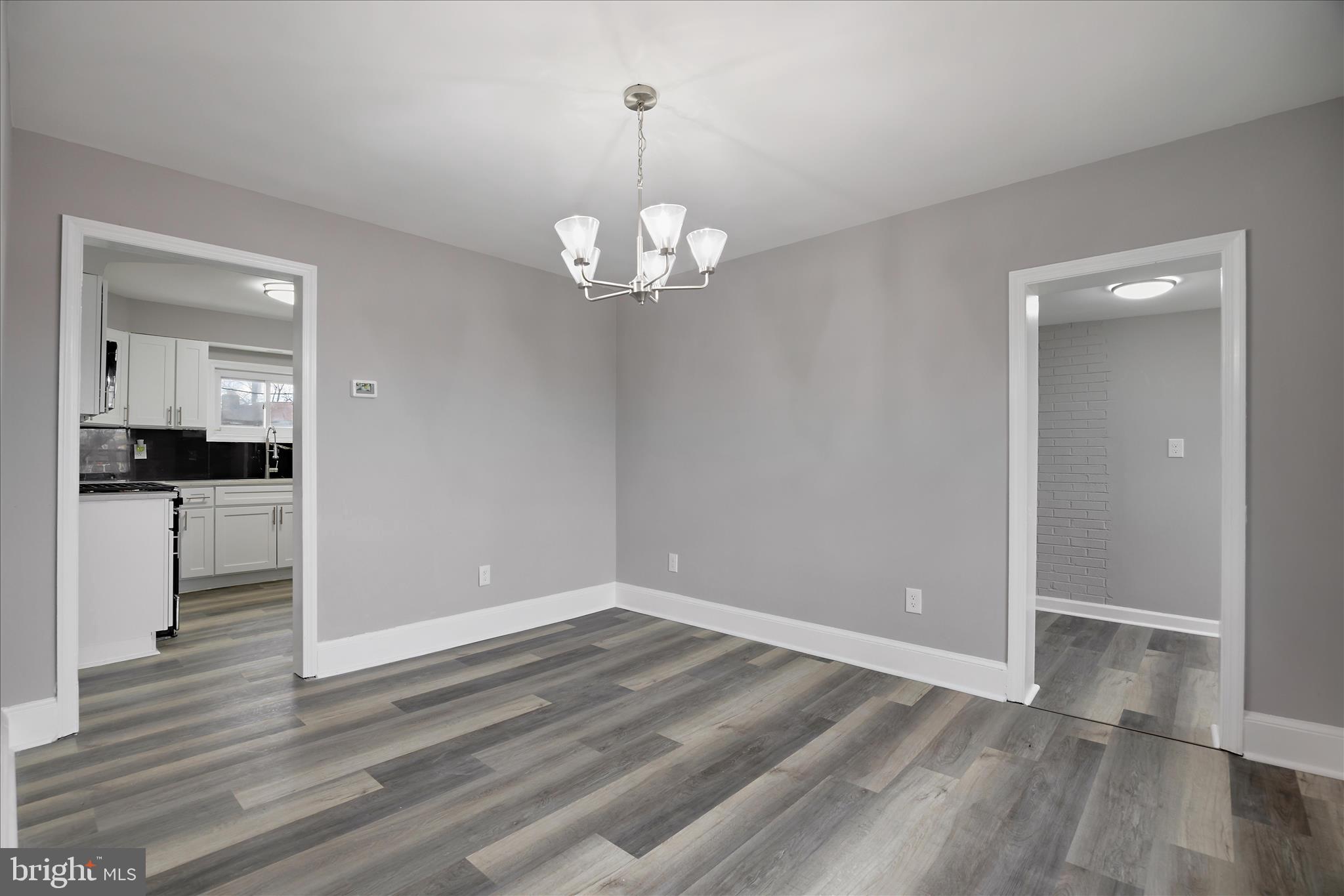 4007 Forestville Road District Heights, MD 20747 - Photo 9 of 45 wooden floor in an empty room with a kitchen