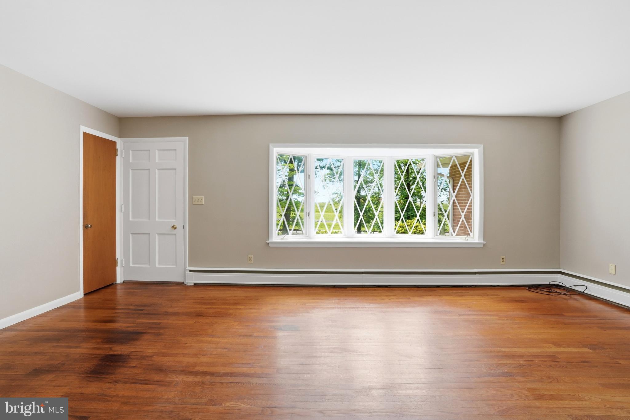 486 Derstine Road Hatfield, PA 19440 - Photo 8 of 53 a view of an empty room with wooden floor and a window