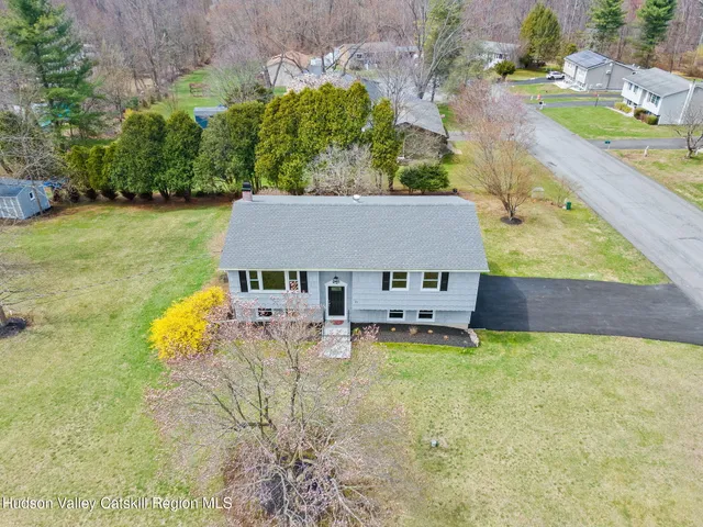 an aerial view of a house with swimming pool garden and patio
