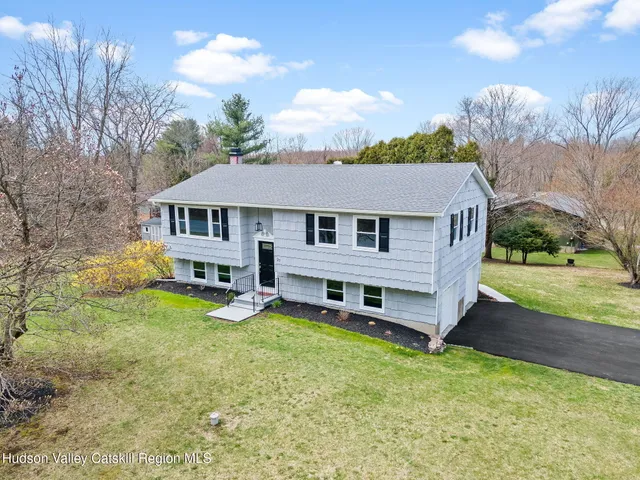 a view of a house with a yard balcony and sitting area