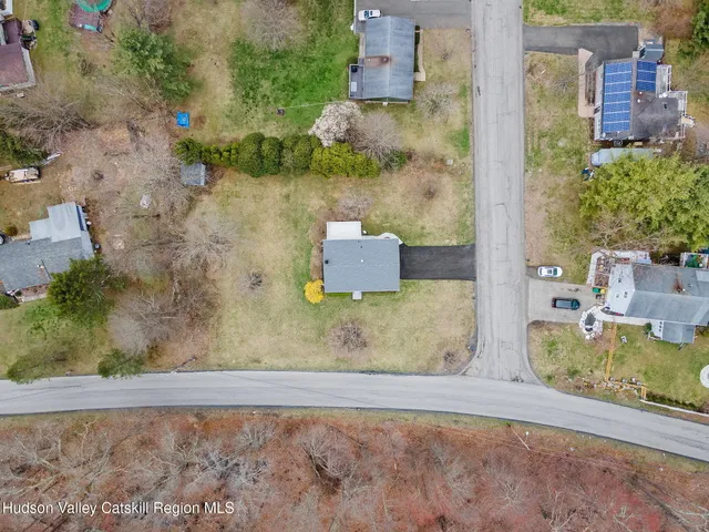 an aerial view of a house with a yard