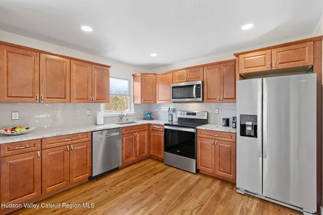 a kitchen with wooden cabinets and stainless steel appliances