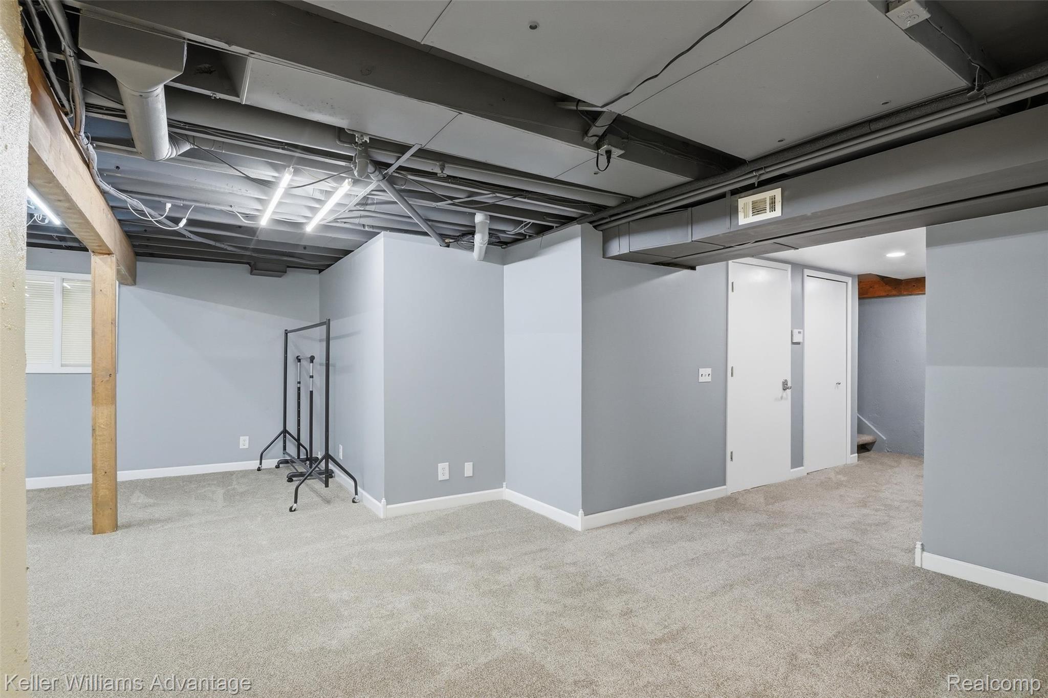 42505 Saltz Road Canton, MI 48187 - Photo 30 of 52 Finished basement with light colored carpet and baseboards