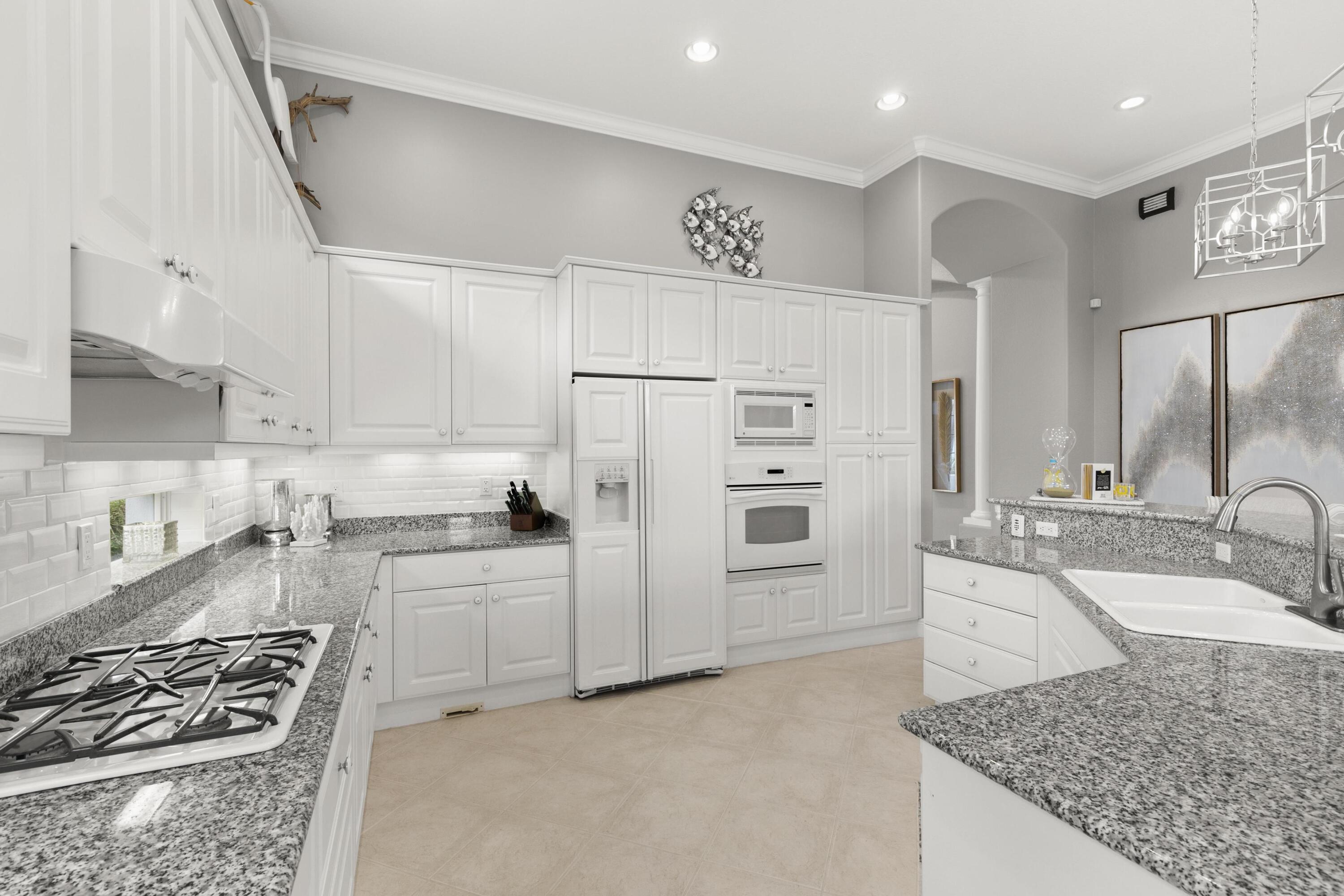 9100 Cherry Oaks Trail Naples, FL 34114 - Photo 11 of 33 a kitchen with stainless steel appliances granite countertop a sink stove and refrigerator