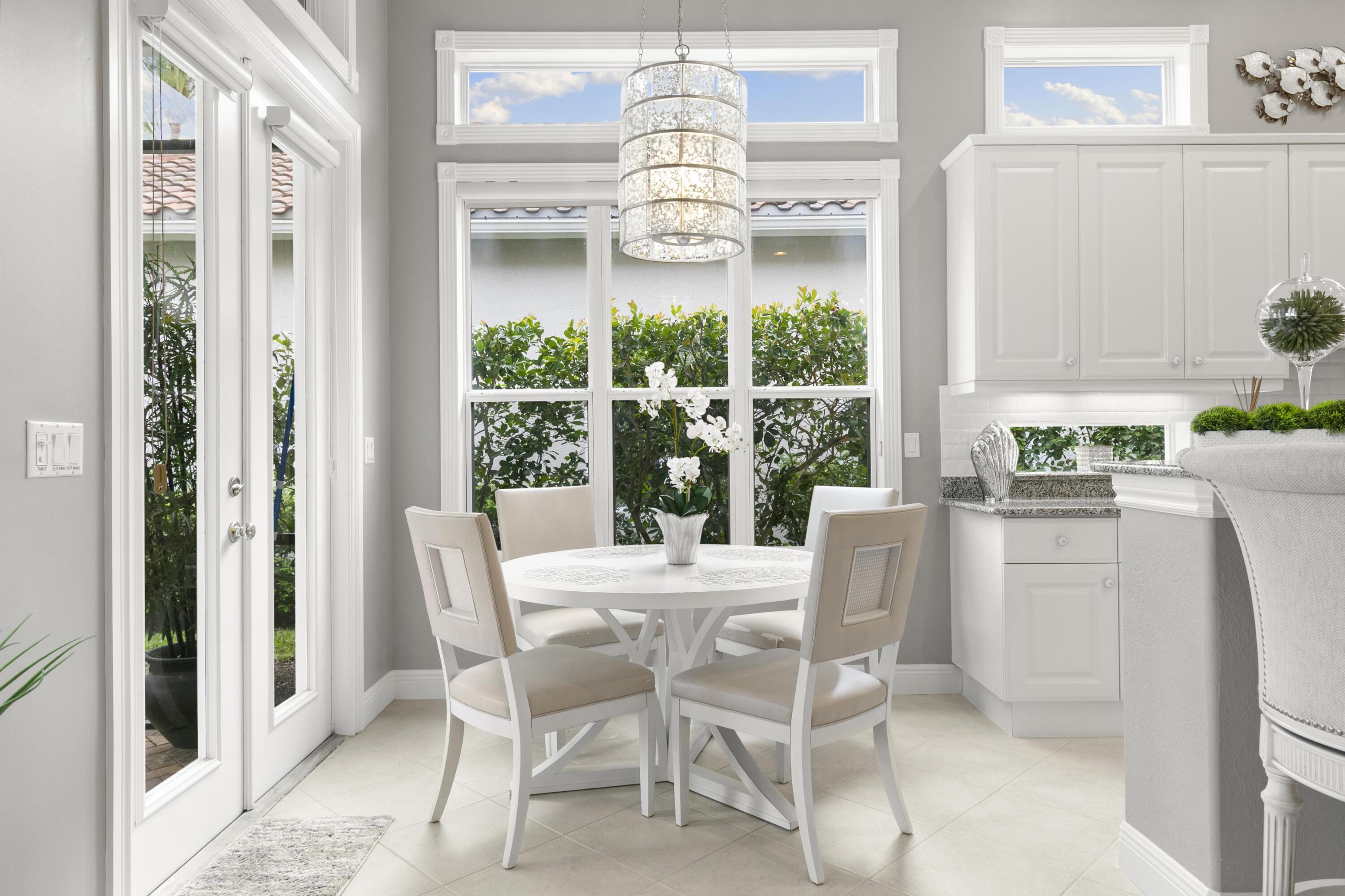 9100 Cherry Oaks Trail Naples, FL 34114 - Photo 12 of 33 a dining room with furniture a chandelier and a rug