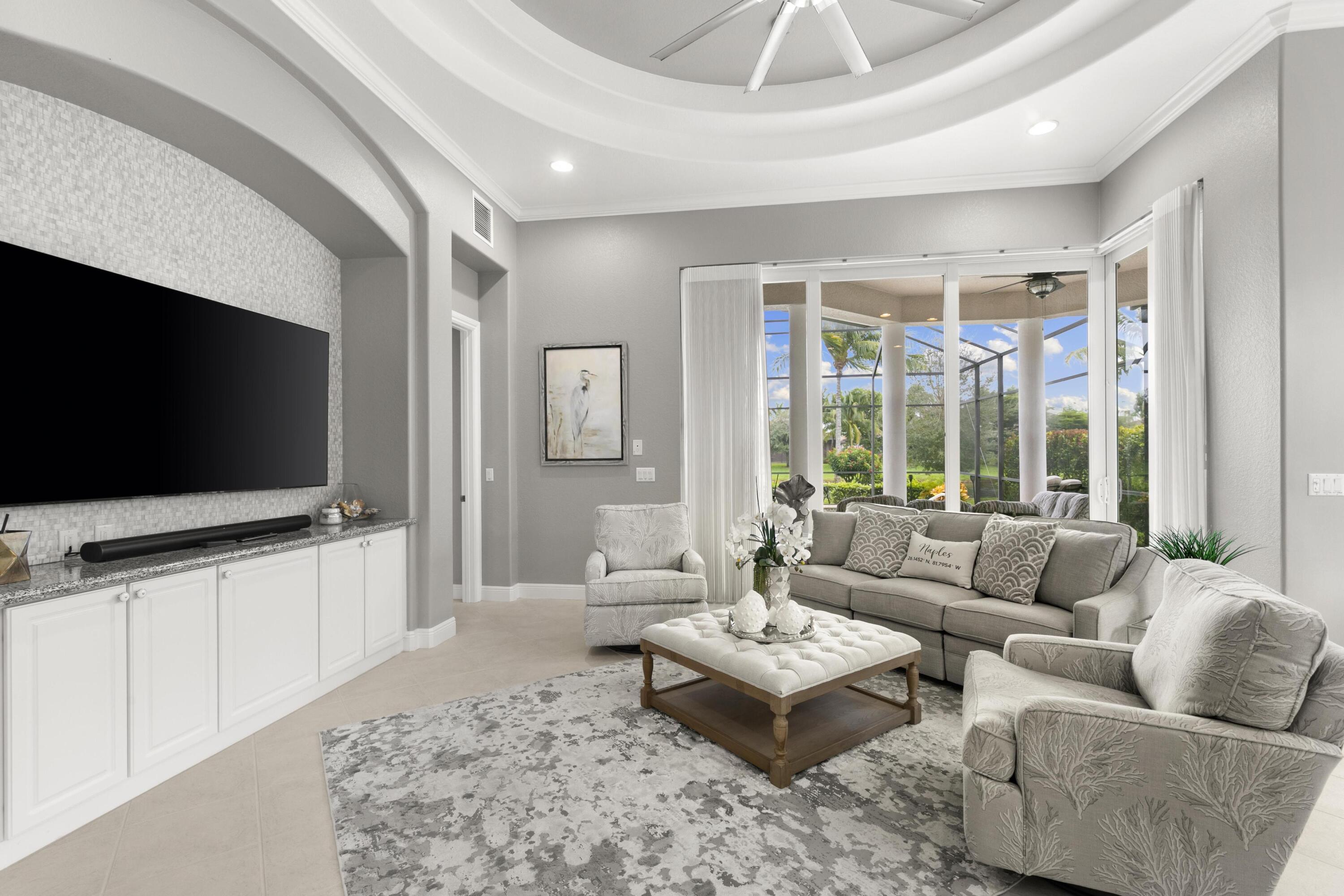 9100 Cherry Oaks Trail Naples, FL 34114 - Photo 13 of 33 a living room with furniture and a flat screen tv