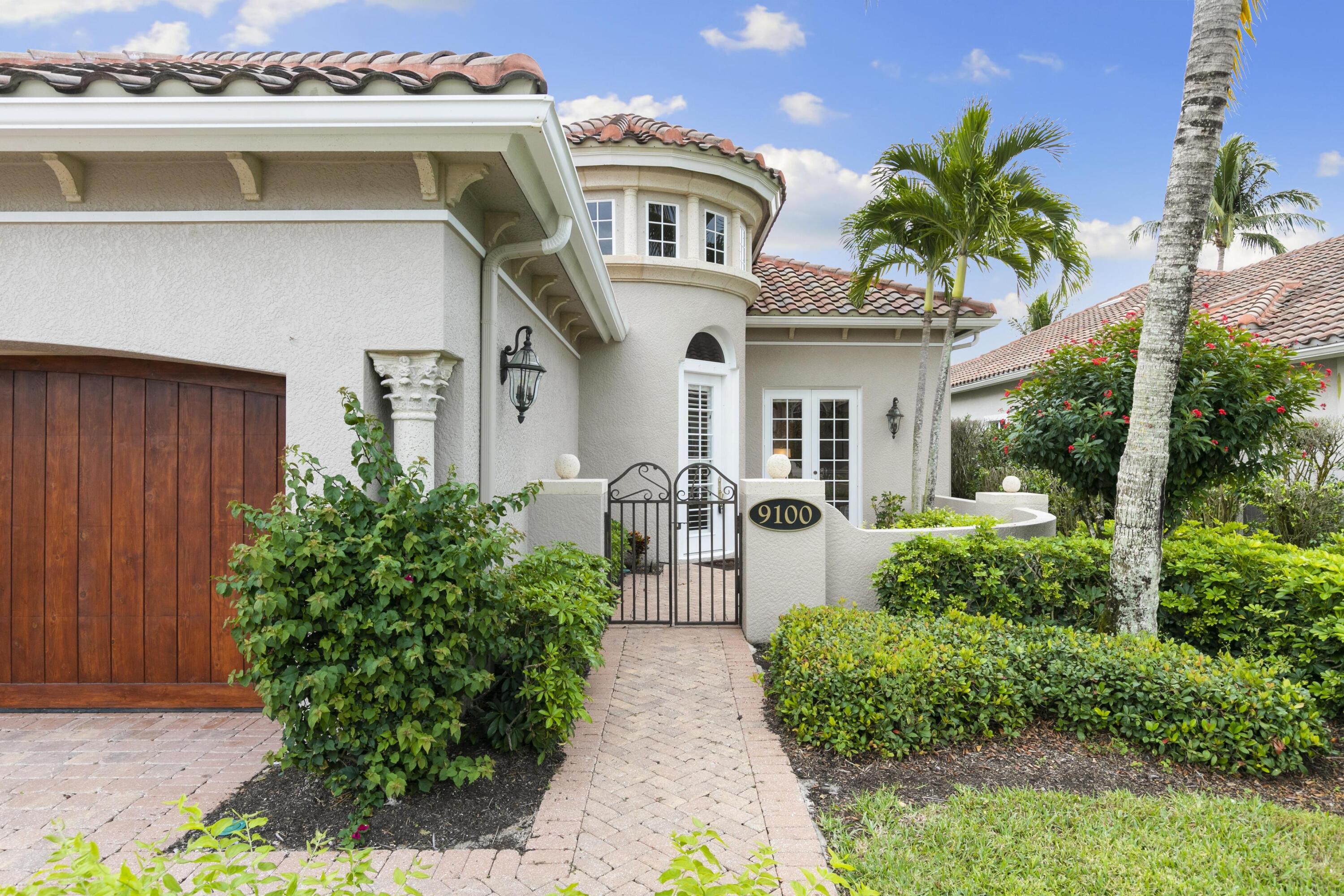 9100 Cherry Oaks Trail Naples, FL 34114 - Photo 2 of 33 a front view of a house with garden