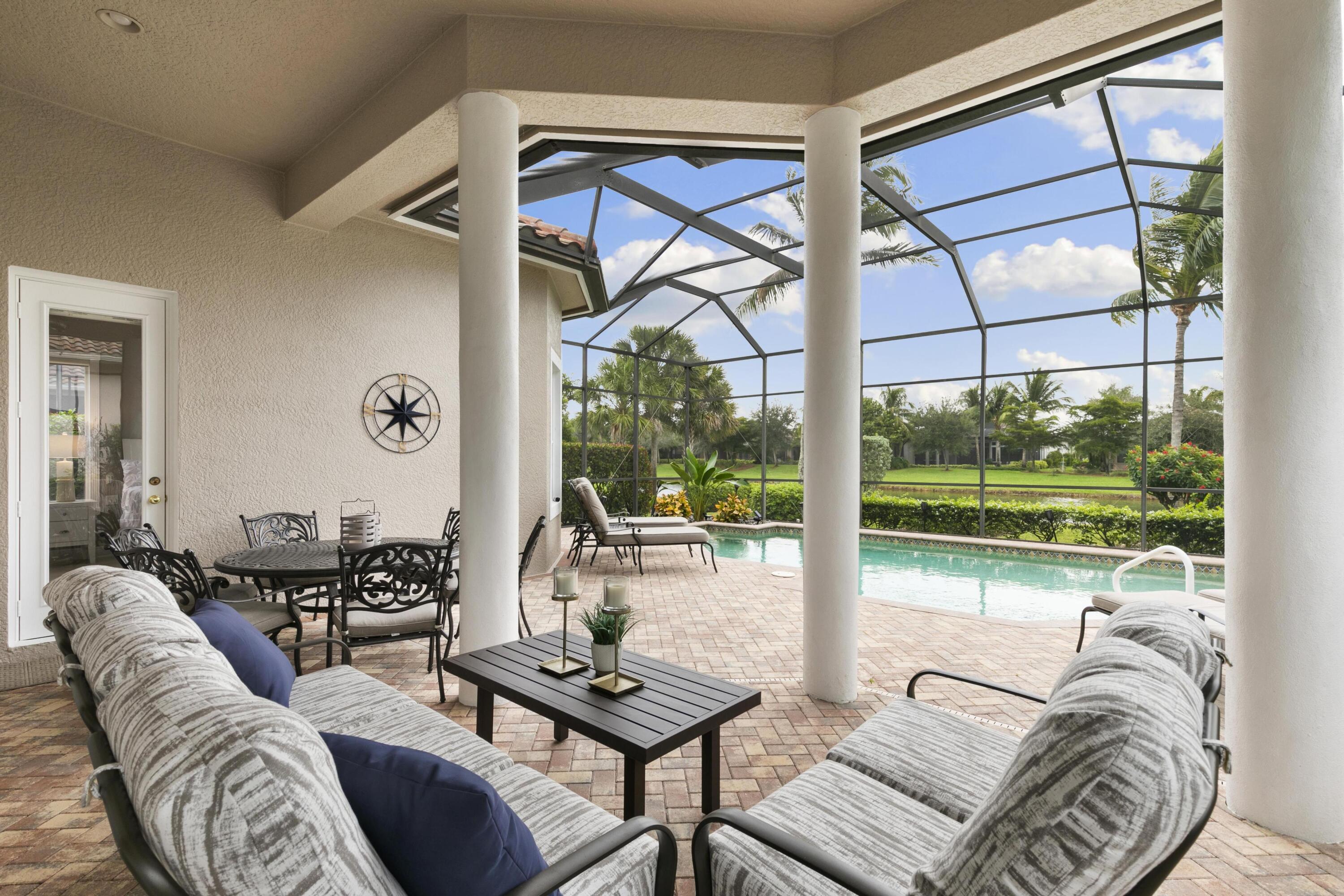 9100 Cherry Oaks Trail Naples, FL 34114 - Photo 22 of 33 a living room with furniture and a floor to ceiling window