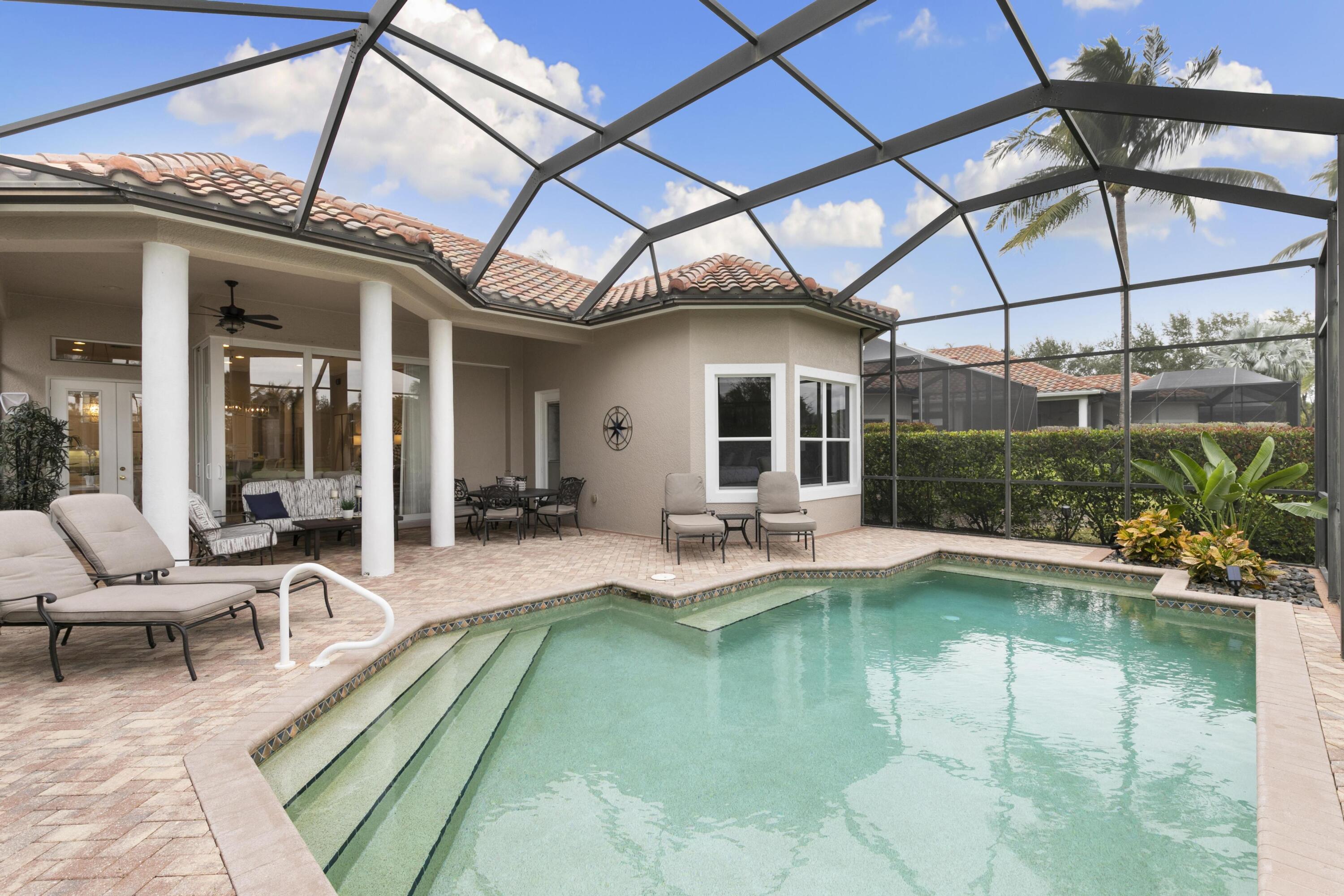 9100 Cherry Oaks Trail Naples, FL 34114 - Photo 24 of 33 a view of a patio with couches chairs and swimming pool table and chairs