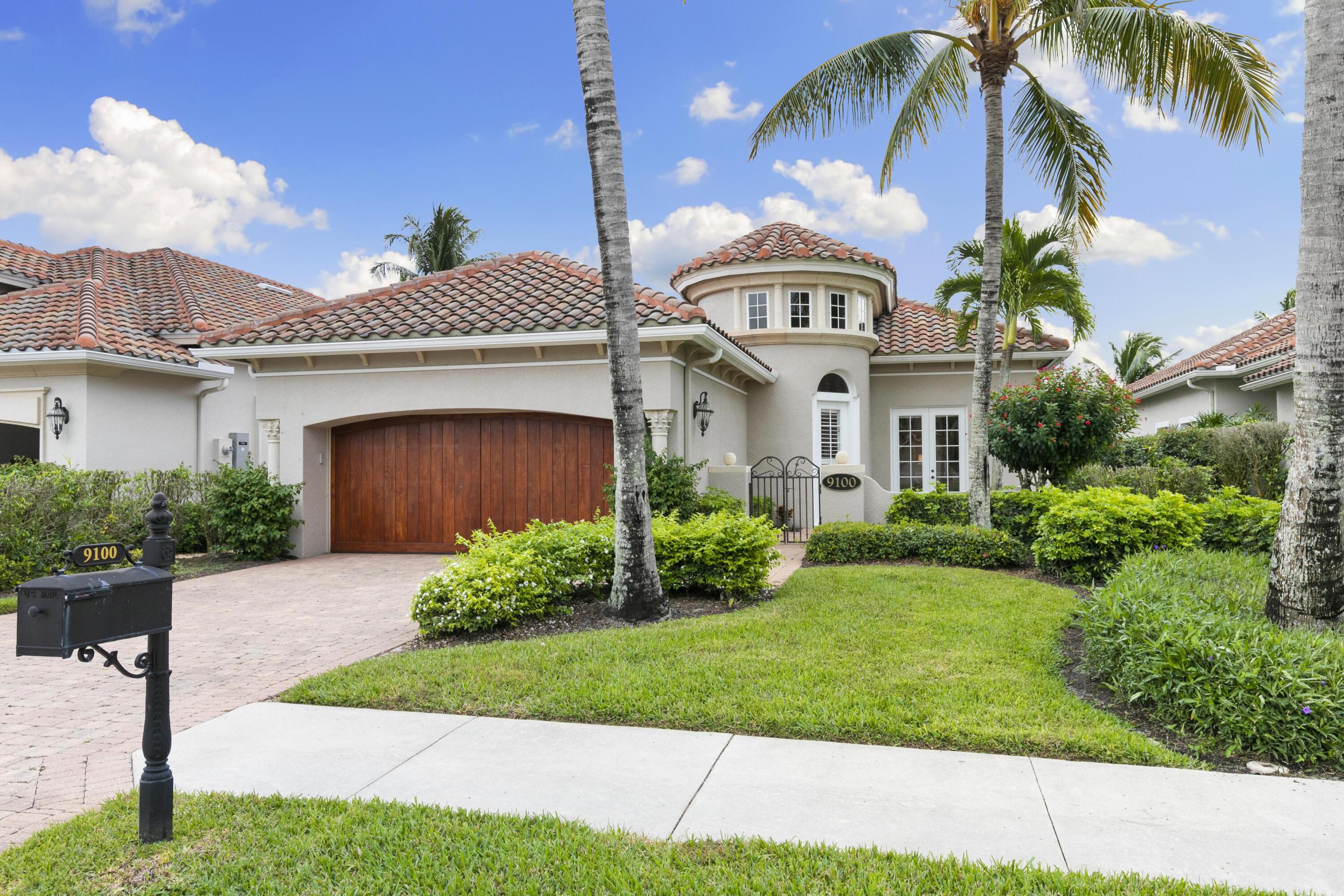 9100 Cherry Oaks Trail Naples, FL 34114 - Photo 3 of 33 a front view of a house with a garden and entryway