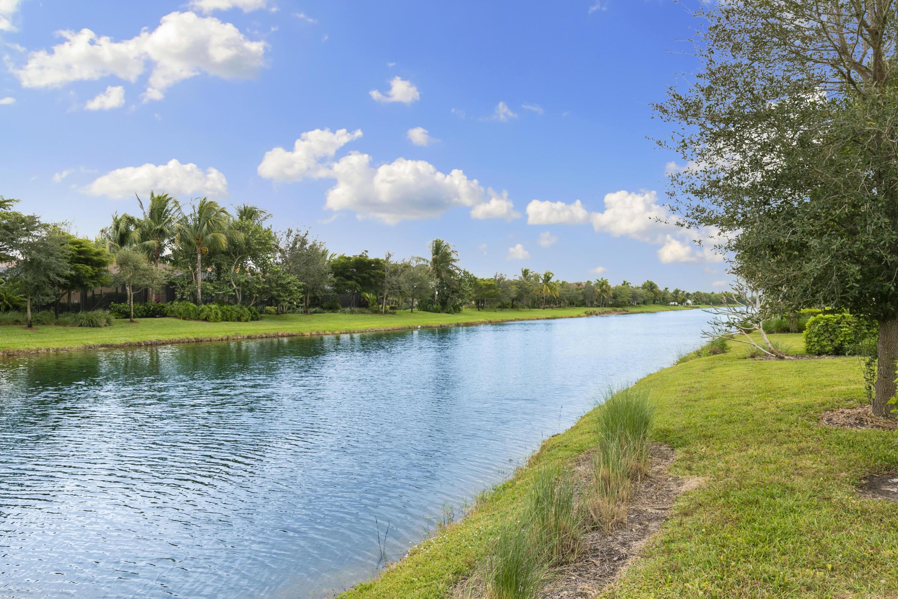 9100 Cherry Oaks Trail Naples, FL 34114 - Photo 31 of 33 a view of a lake with a big yard