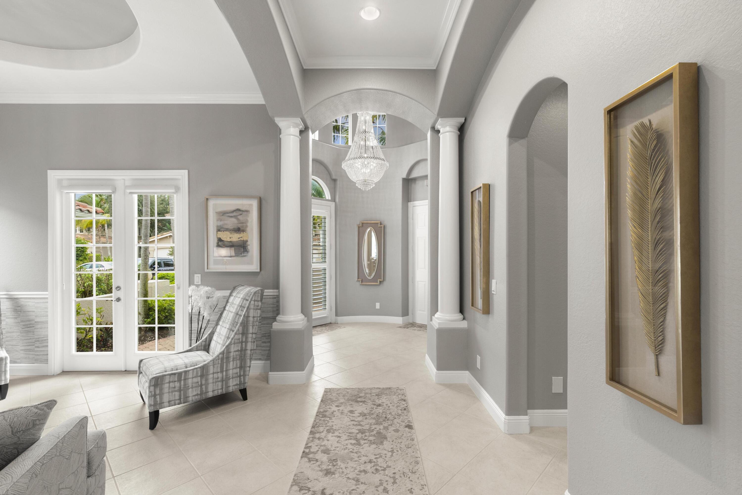 9100 Cherry Oaks Trail Naples, FL 34114 - Photo 6 of 33 a living room with furniture and a chandelier