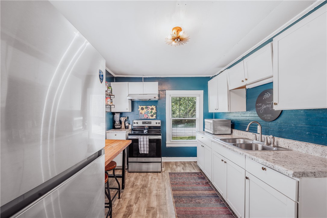 310 North Chestnut Street Seneca, SC 29678 - Photo 25 of 30 A compact kitchen offering streamlined functionality with essential appliances and a charming dining nook.