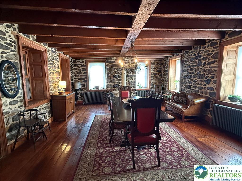 940 Jacktown Road Bangor, PA 18013 - Photo 10 of 33 Exposed stone walls and rich wood beams frame this character-filled dining area, perfect for intimate gatherings.