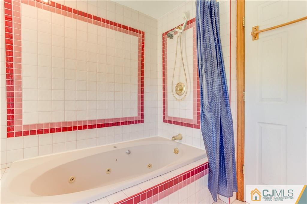 659 Ridge Road Monmouth Junction, NJ 08852 - Photo 19 of 24 a bathroom with a bathtub and shower