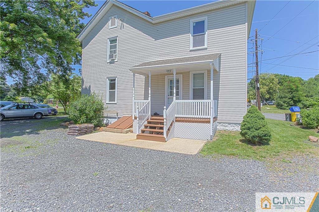 659 Ridge Road Monmouth Junction, NJ 08852 - Photo 22 of 24 a front view of a house with a yard and garage
