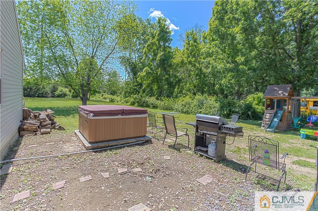 659 Ridge Road Monmouth Junction, NJ 08852 - Photo 23 of 24 a view of a backyard with table and chairs