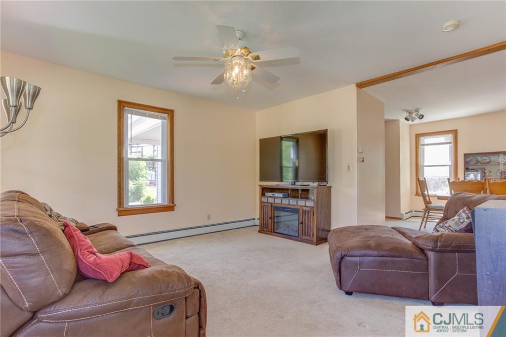 659 Ridge Road Monmouth Junction, NJ 08852 - Photo 7 of 24 a living room with furniture and a flat screen tv