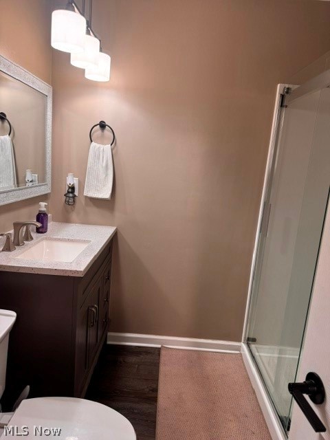 2760 Haines Road Madison, OH 44057 - Photo 31 of 33 Bathroom featuring a dark wood-finish vanity with a light-speckled countertop, a rectangular sink with a chrome faucet, and a frameless mirror with a textured border