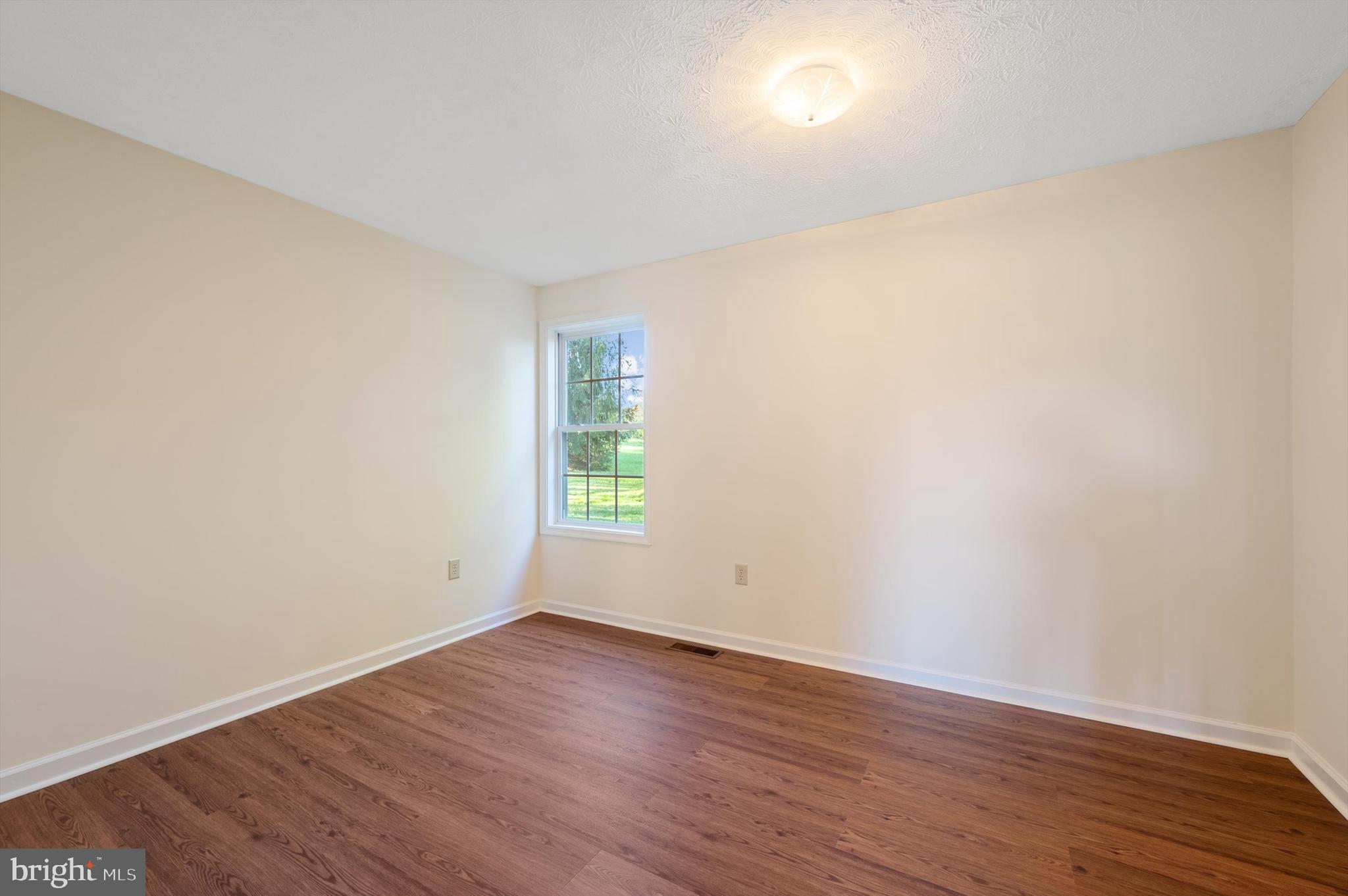 2801 Salem Church Road Berryville, VA 22611 - Photo 24 of 68 a view of an empty room with wooden floor and a window