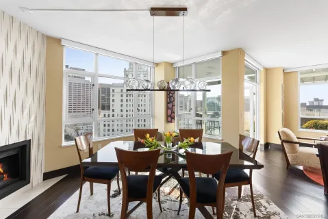 a living room with furniture and a dining table with wooden floor