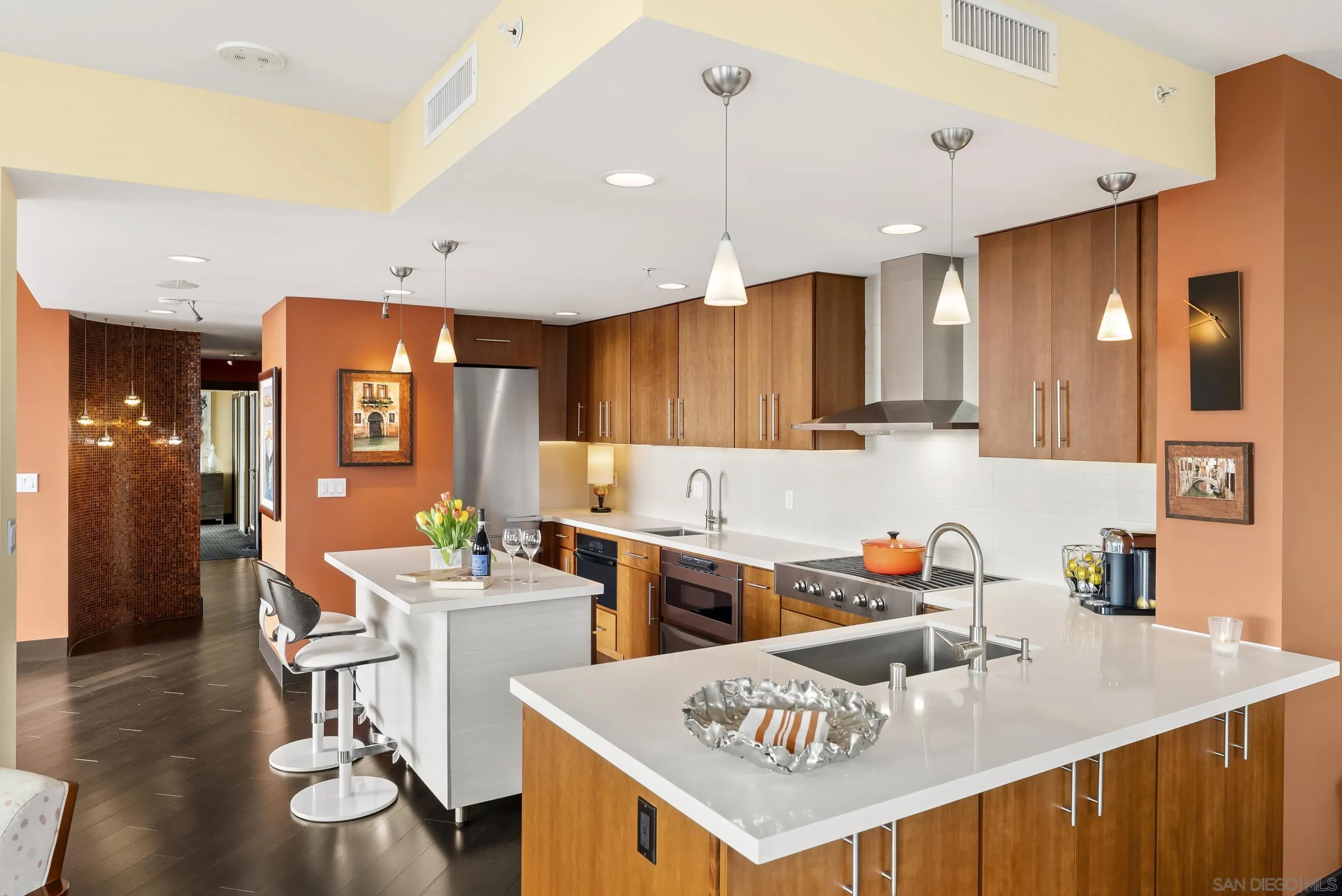 850 Beech Street, Unit 1205 San Diego, CA 92101 - Photo 27 of 66 a kitchen with a sink a stove and chairs