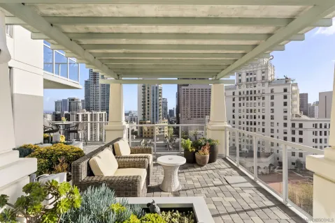 a living room with stainless steel appliances kitchen island granite countertop furniture and a large window