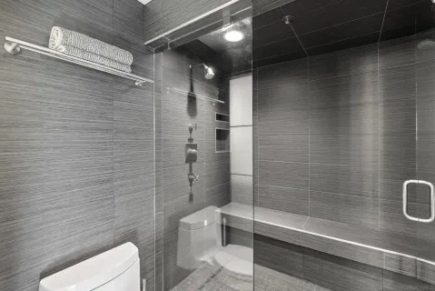 a row of palm trees in front of a house