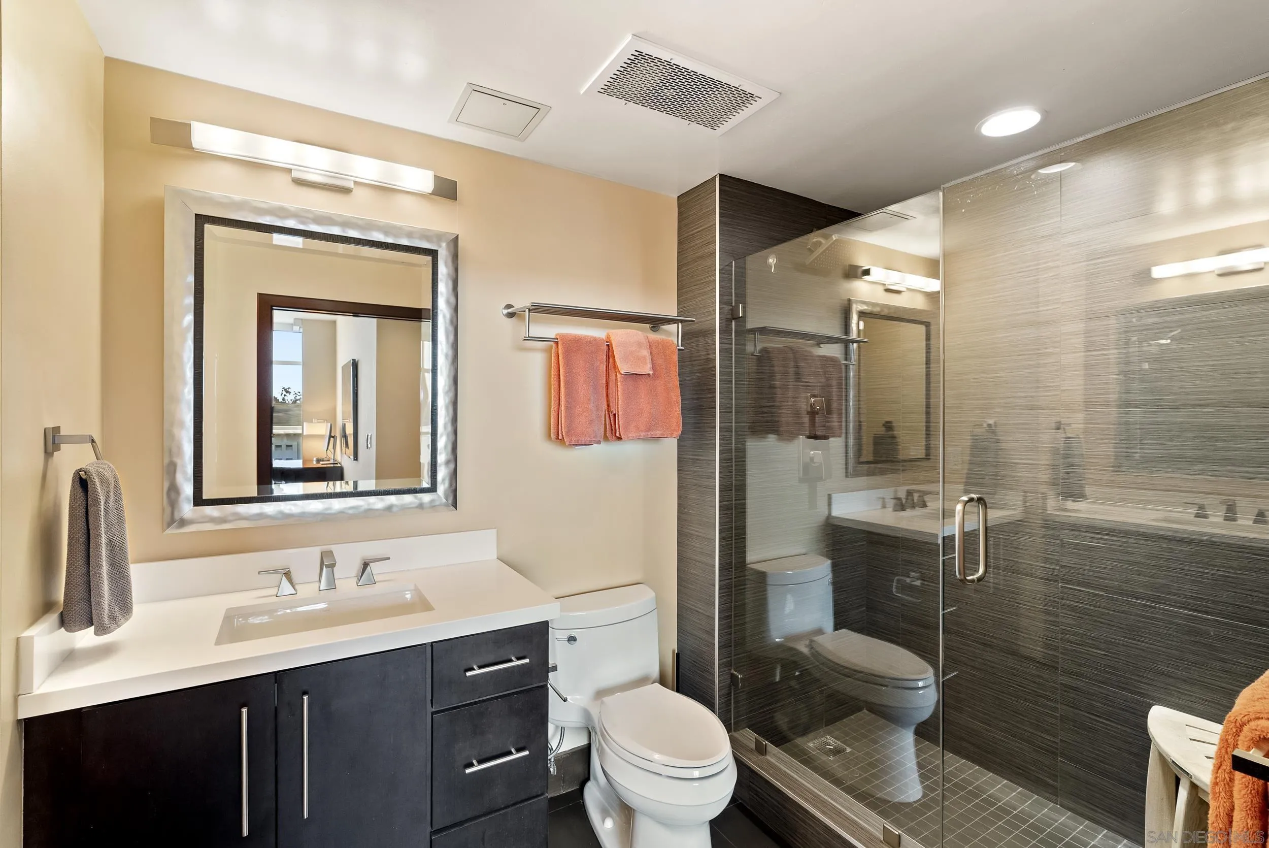 850 Beech Street, Unit 1205 San Diego, CA 92101 - Photo 51 of 66 a bathroom with a toilet a sink a mirror a vanity and shower