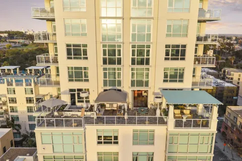 a very nice looking kitchen with a large window a sink and living room view