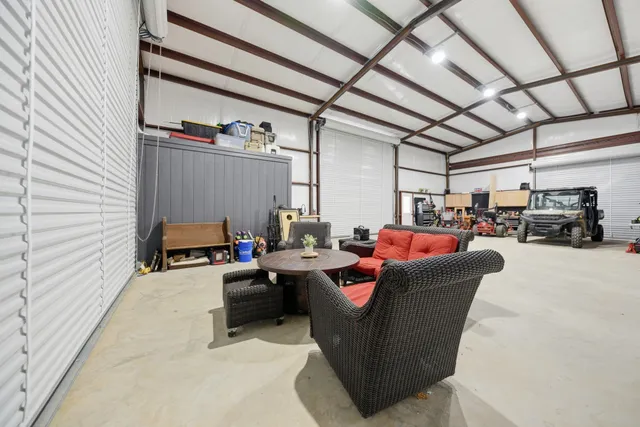 a dining room with furniture and a chandelier