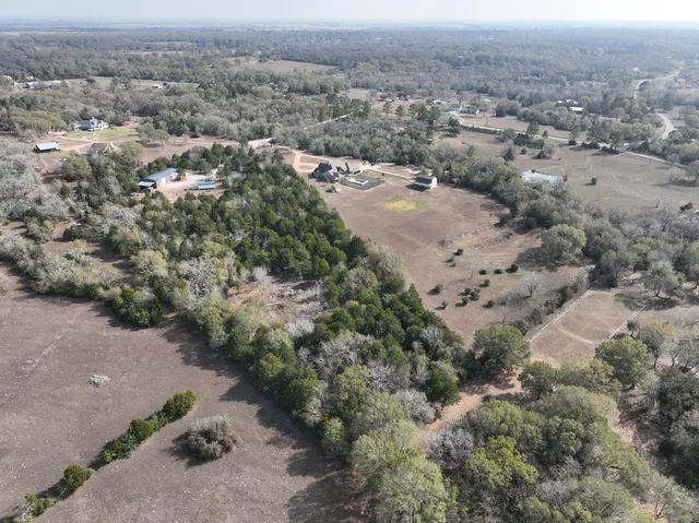 an aerial view of a houses with a yard