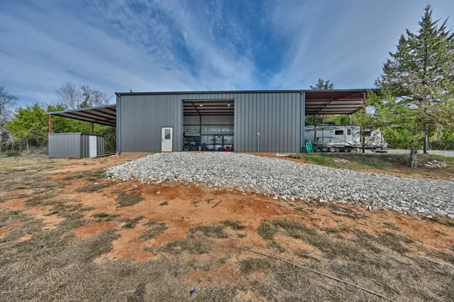 a view of a house with a yard and garage