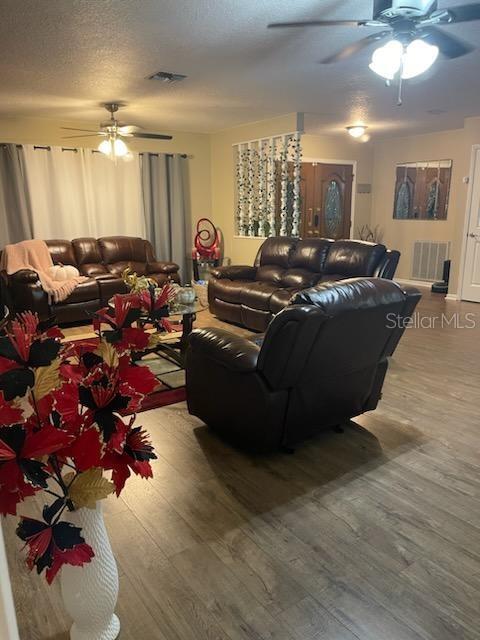 5118 Merrifield Court Spring Hill, FL 34608 - Photo 12 of 13 a living room with furniture flowers and a chandelier