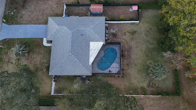 an aerial view of a house with a yard