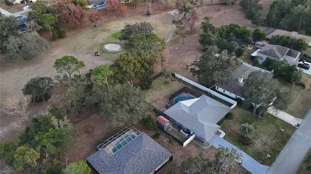 an aerial view of a house with a yard and garden