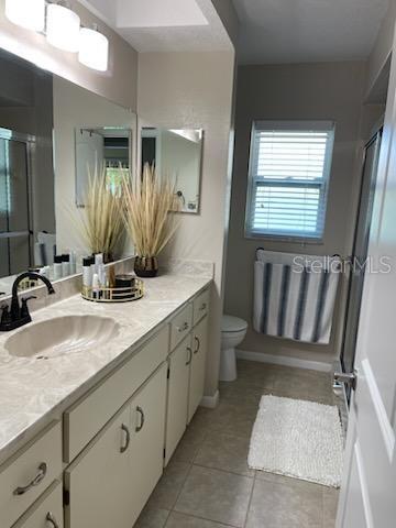 5118 Merrifield Court Spring Hill, FL 34608 - Photo 9 of 13 a bathroom with a double vanity sink and a mirror