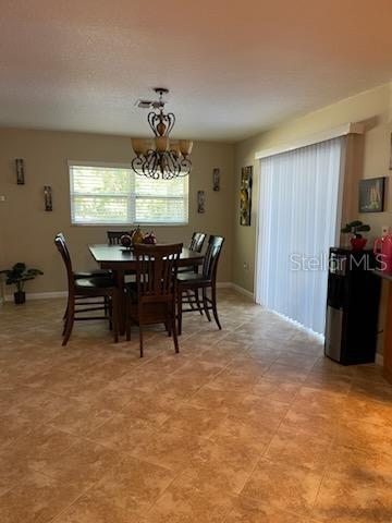 5118 Merrifield Court Spring Hill, FL 34608 - Photo 10 of 13 a view of a dining room with furniture window and outside view