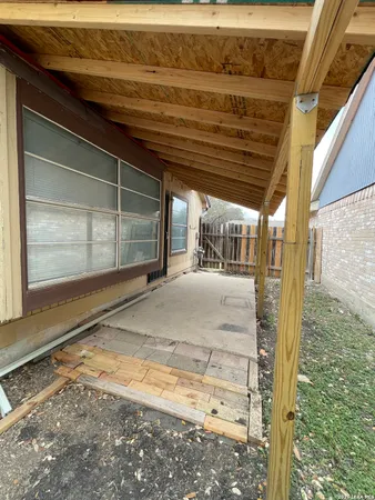a view of backyard with wooden fence