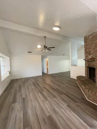 wooden floor in an empty room with a fireplace