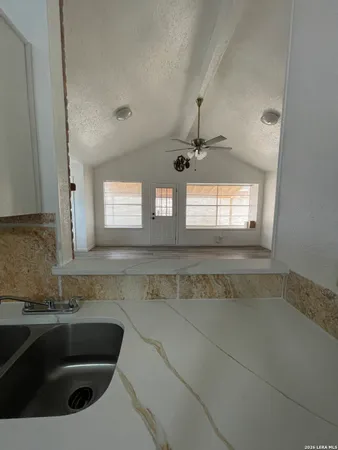a view of a kitchen sink and chandelier