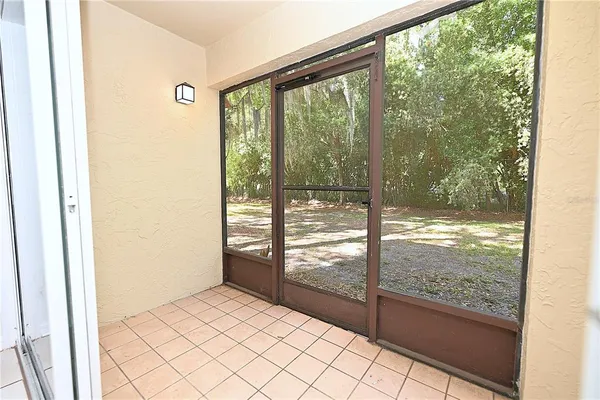 a view of empty room with wooden floor and floor to ceiling window