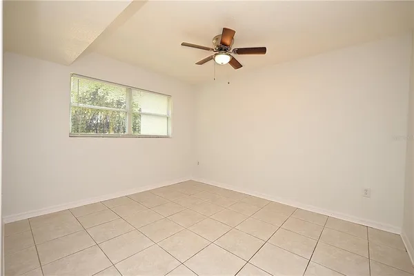 a view of a room with a window and a fan