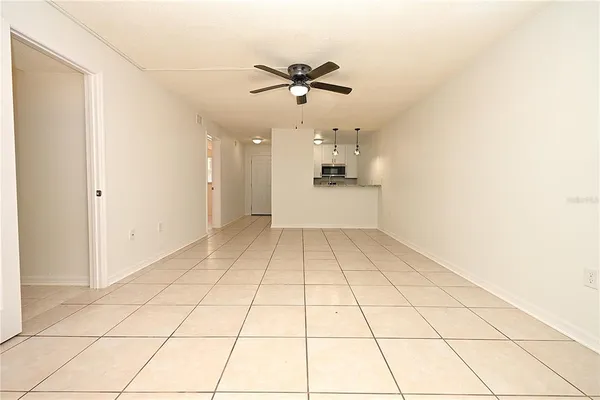 a view of a room with wooden floor and white walls
