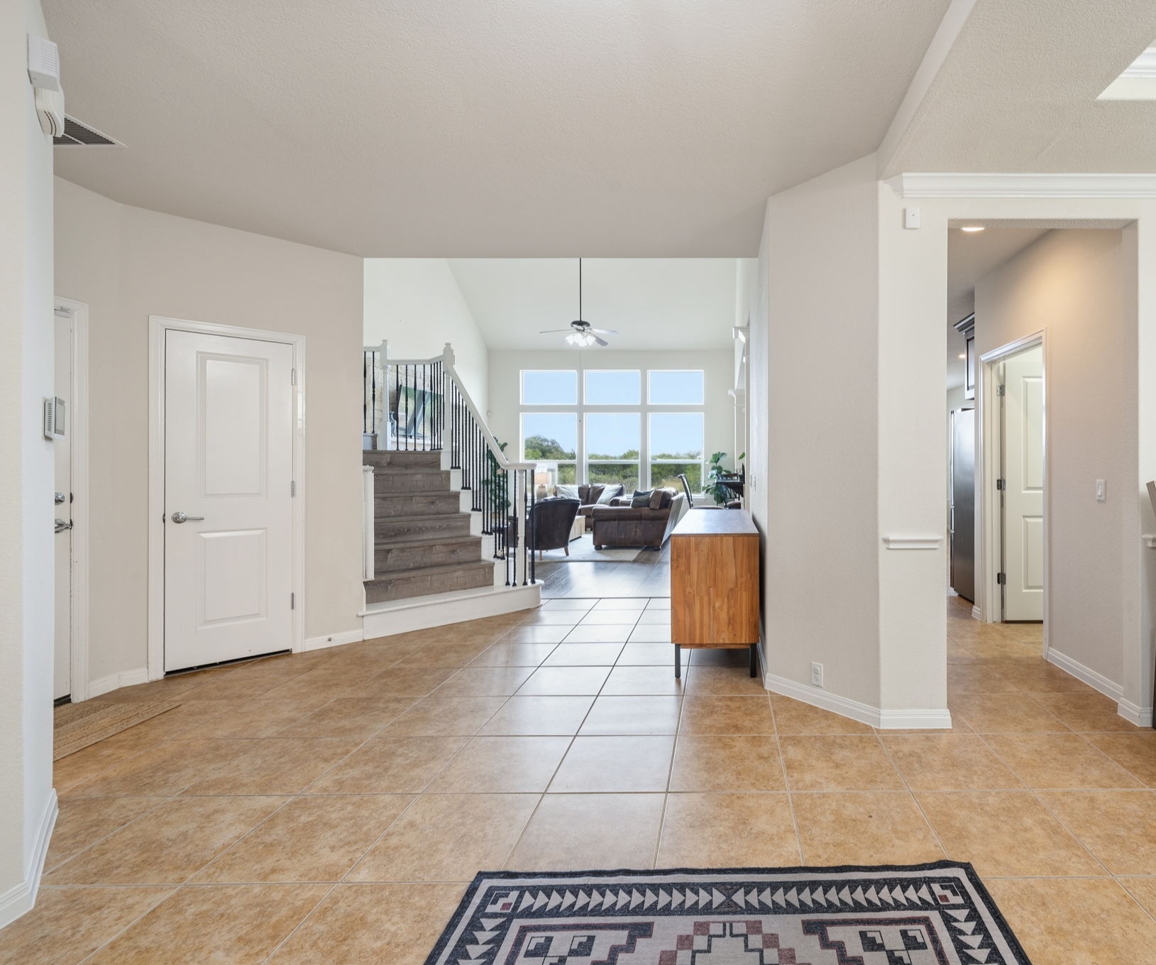 1581 Grassy Field Road Austin, TX 78737 - Photo 4 of 37 Durable tile flooring guides the eye through this spacious entry towards the main living area.