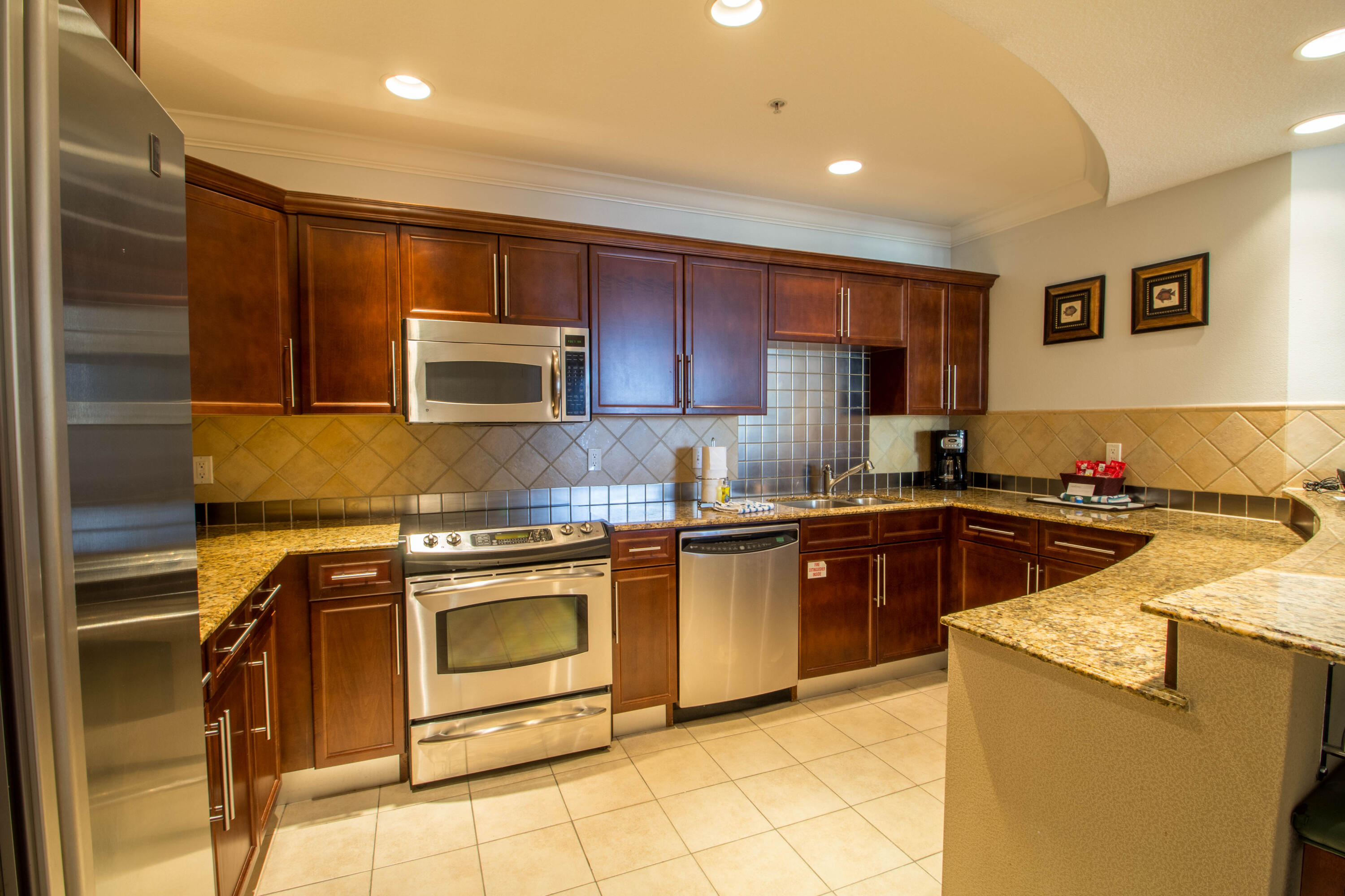 10 Harbor Boulevard, Unit E802C Destin, FL 32541 - Photo 6 of 24 a kitchen with granite countertop a sink and a stove top oven
