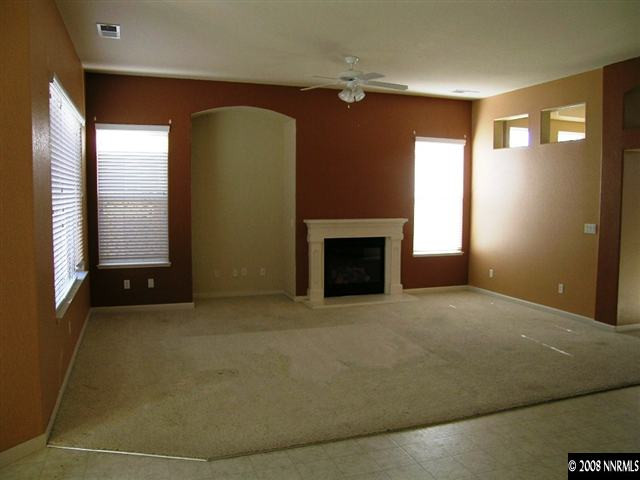 10410 Chantilly Way Reno, NV 89521 - Photo 3 of 8 a view of empty room with window and fireplace