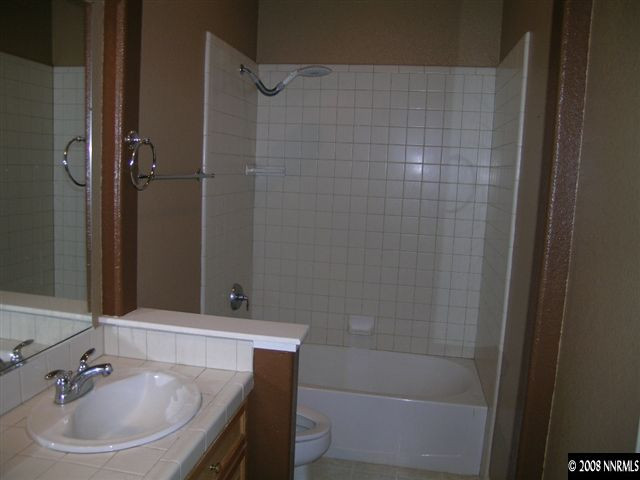 10410 Chantilly Way Reno, NV 89521 - Photo 8 of 8 a bathroom with a sink a shower and a mirror