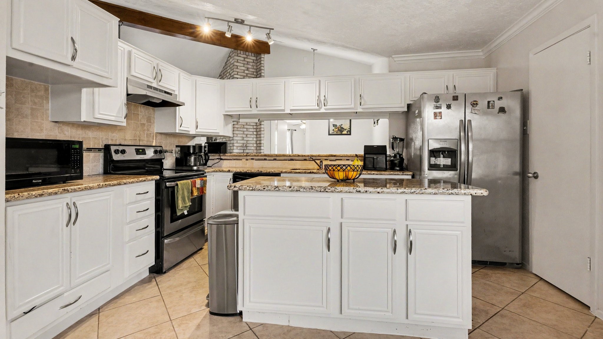 1506 Holbech Lane Channelview, TX 77530 - Photo 6 of 21 a kitchen with stainless steel appliances granite countertop a refrigerator sink and white cabinets