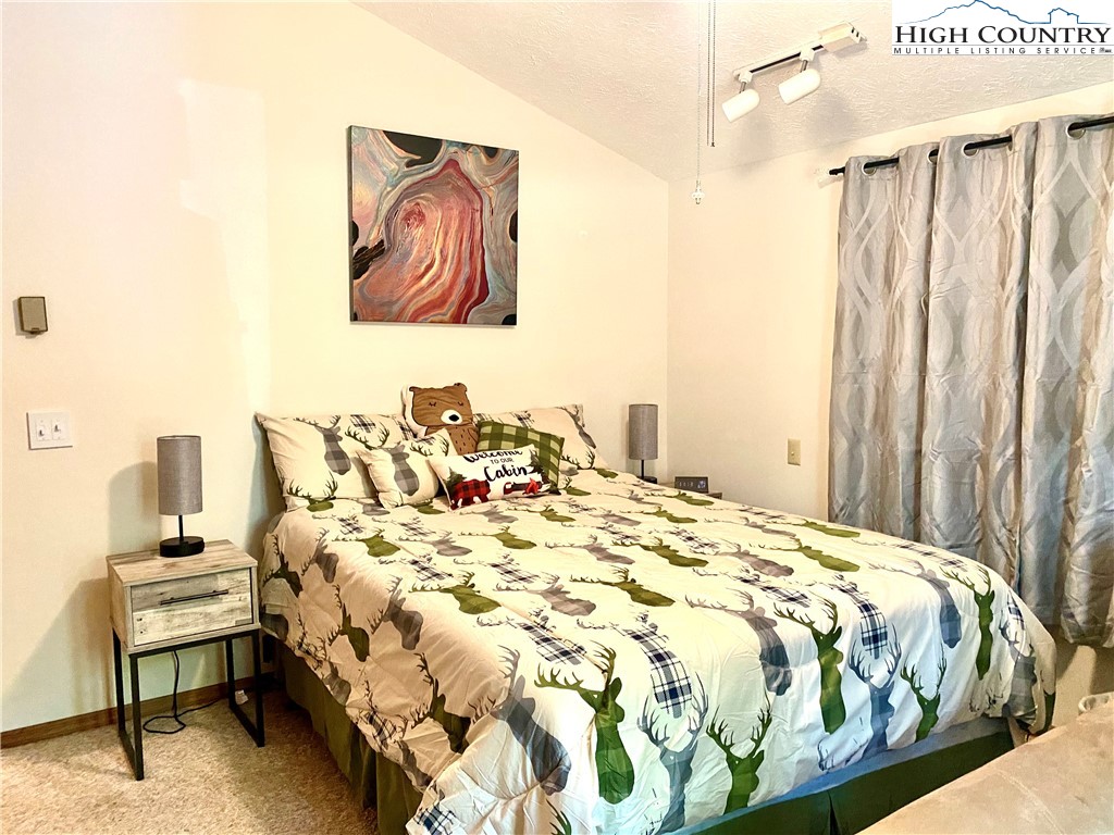 175 Ash Loop Newland, NC 28657 - Photo 22 of 46 a bed sitting in a bedroom next to a cabinet